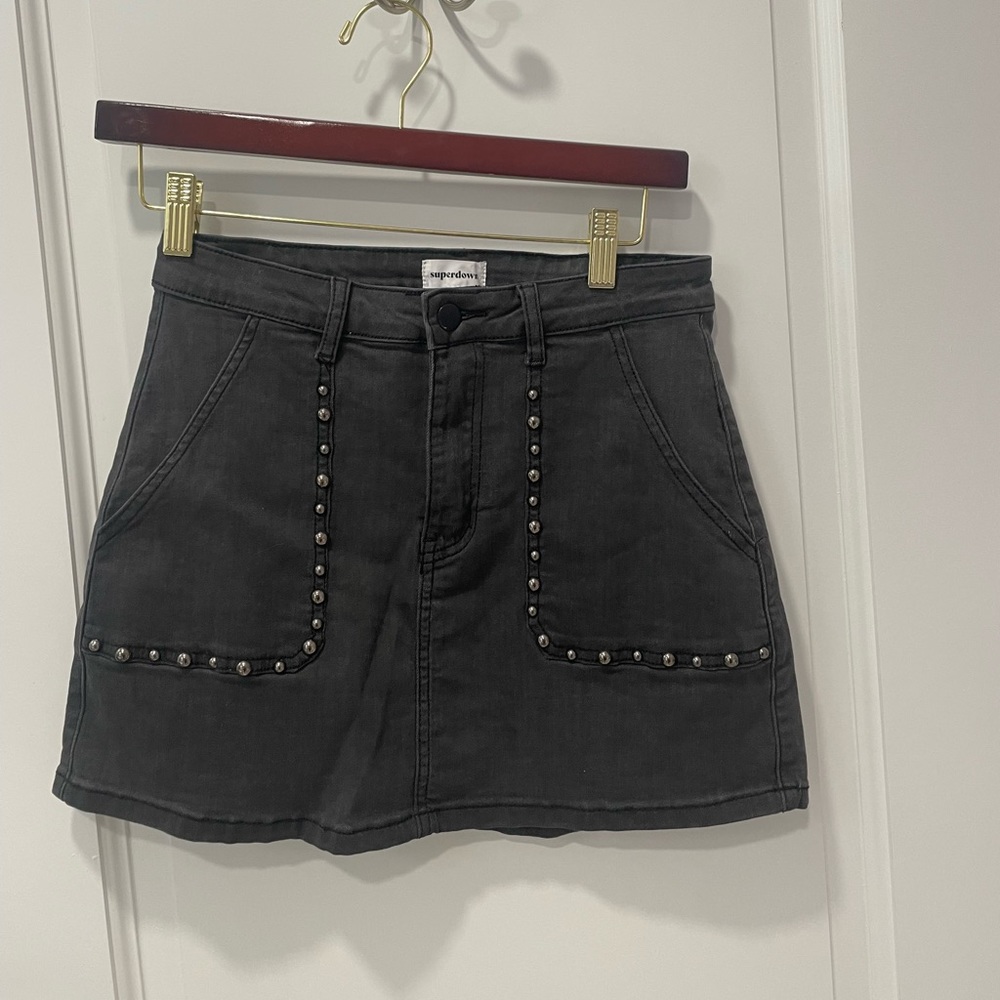 Super down black denim mini skirt with embellishment at pockets
